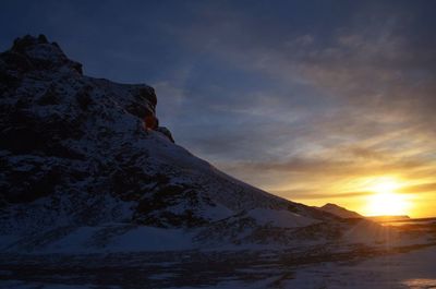 Scenic view of snowcapped mountains against sky during sunset