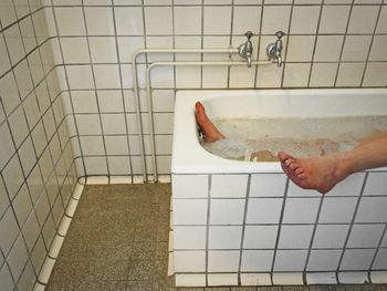 High angle view of hands in bathroom