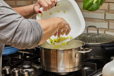 Cropped hand of man preparing food