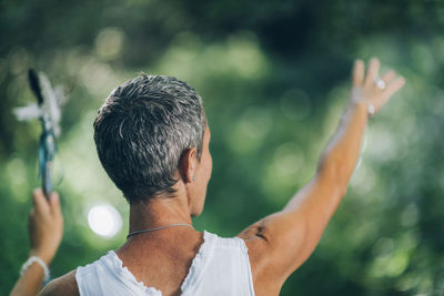 Rear view of man with arms raised