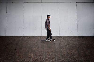 Full length of man skateboarding on wall
