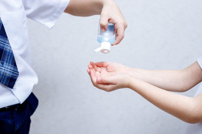 Midsection of couple holding hands