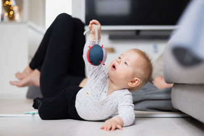 High angle view of cute girl sitting on floor at home