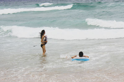 Full length of friends on beach