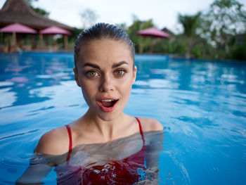 Portrait of smiling young woman in swimming pool