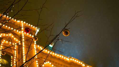 Low angle view of illuminated christmas lights at night