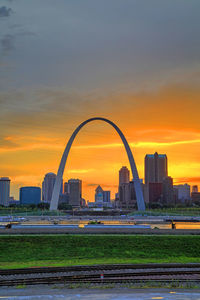 Modern buildings against sky during sunset in city