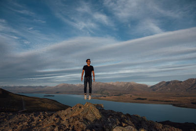 Full length of man jumping on cliff