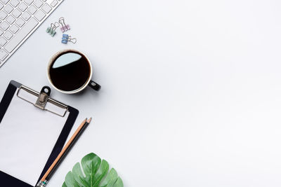 Directly above shot of coffee cup against white background