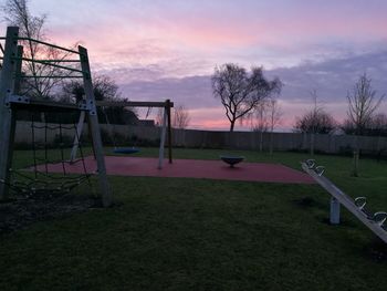 Playground against sky during sunset