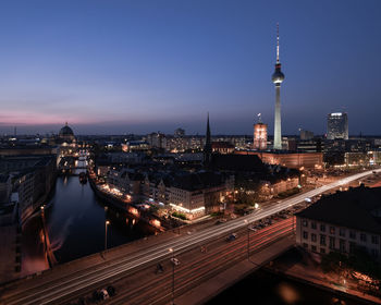 High angle view of city lit up at night