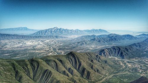 Scenic view of dramatic landscape against clear blue sky