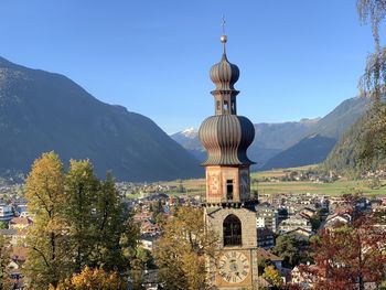 Panoramic view of buildings and mountains against clear sky