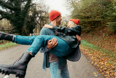 A young couple in love is fooling around on a walk. valentine's day concept.