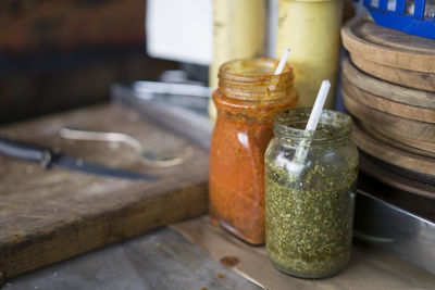 Close-up of sauce jars on table