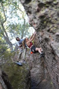 Rear view of man climbing on rock