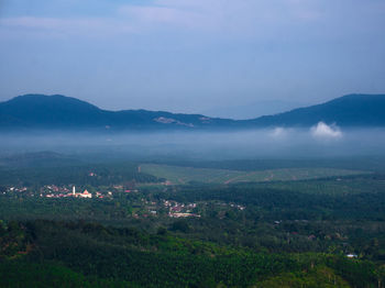 Scenic view of landscape and mountains against sky