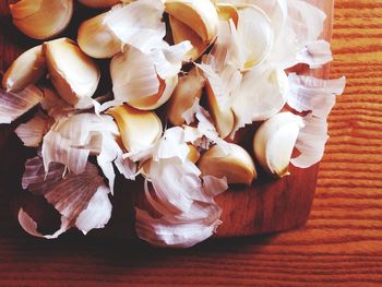 High angle view of peeled garlic on table