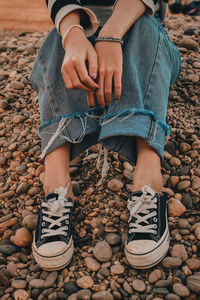 Low section of woman standing on stone