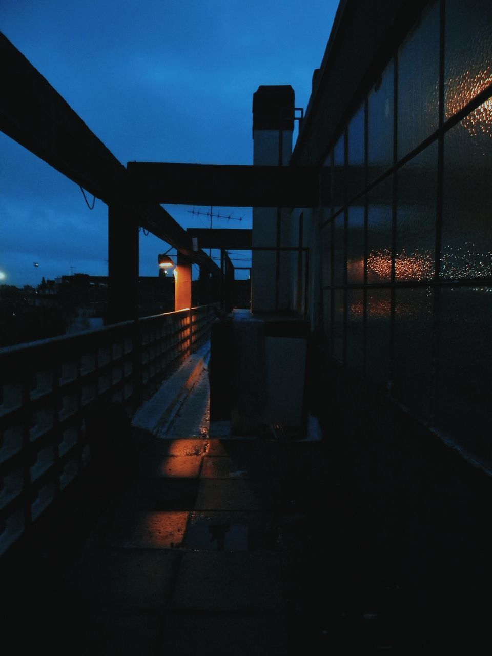 BRIDGE IN CITY AGAINST SKY AT SUNSET