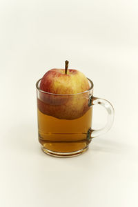 Close-up of drink on table against white background