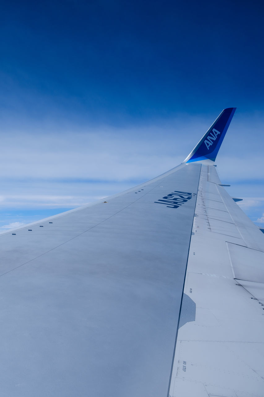 AIRPLANE FLYING OVER BLUE SKY