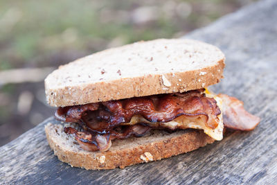 Close-up of meat in bread on wooden table