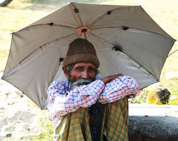 Portrait of man with umbrella