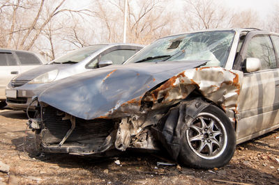 A crumpled hood and a broken windshield of a car that got into an accident.