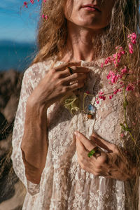 Low section of woman sitting at beach