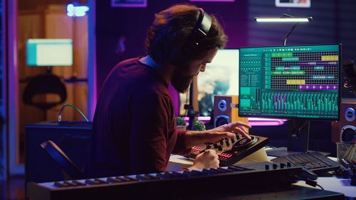 Side view of man using laptop at table