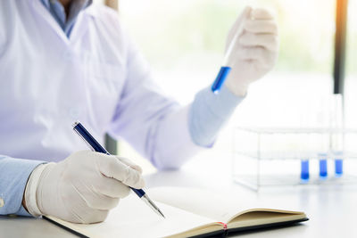Close-up of people working in pen