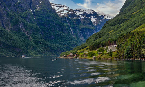 Scenic view of fjord and mountains against sky