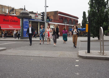 People walking on road in city