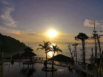 Scenic view of swimming pool against sky during sunset