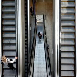 High angle view of people on escalator in building