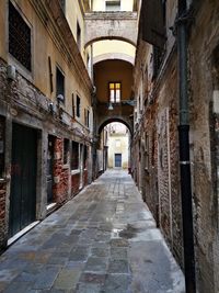 Empty alley amidst buildings in city