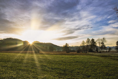 Scenic view of field against sky during sunset