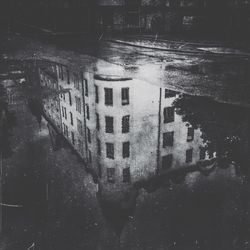 Reflection of buildings in puddle