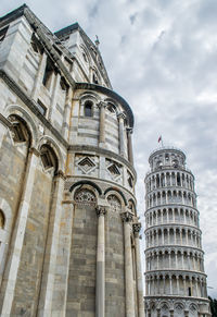 Pisa cathedral and leaning tower in tuscany, italy. low angle view of historical building.