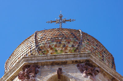 Low angle view of historical building against clear blue sky