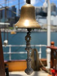 Close-up of lamp post against railing