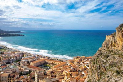 High angle view of townscape by sea against sky