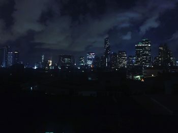 Illuminated city against sky at night