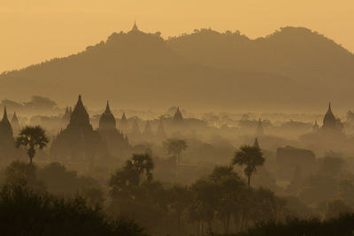 Silhouette town during sunset