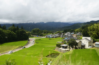 Scenic view of trees and buildings against sky