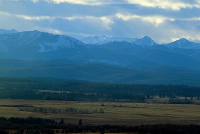 Scenic view of landscape and mountains against sky
