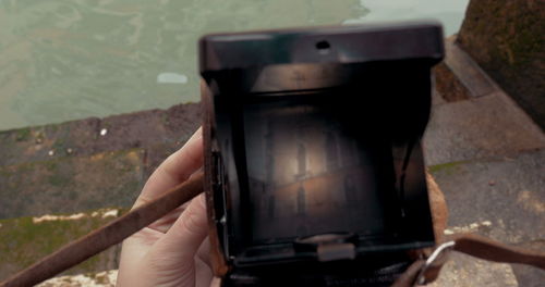 Midsection of man photographing through camera