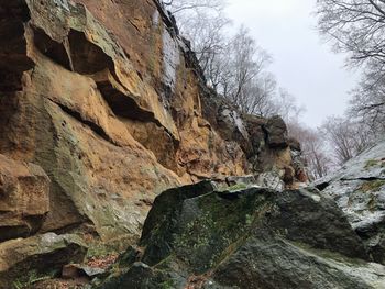 Low angle view of rock formation on mountain against sky