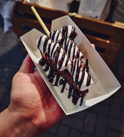 Midsection of person holding chocolate cake